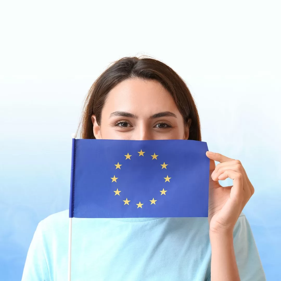 Girl Showing Schengen Flag with a pleasant face